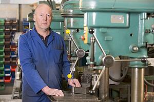 Machinist working on machine
