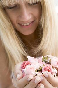 Woman holding a handful of roses