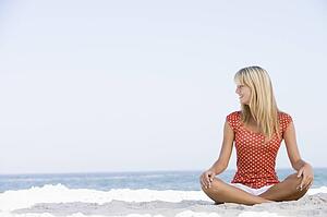 Young woman sitting on a beach