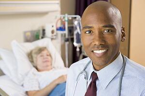 Doctor Smiling, Standing In Hospital Room