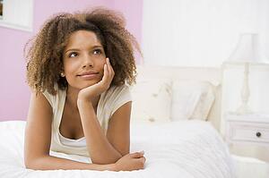 Teenage Girl Lying On Bed