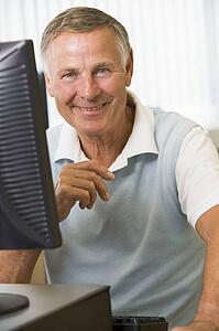 Man sitting at a computer terminal (high key)