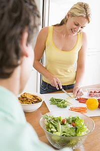Woman Talking To Husband While Preparing meal, mealtime