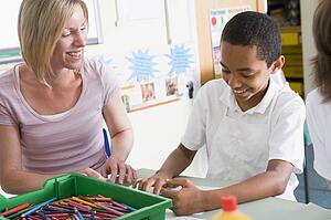 Student in art class with teacher