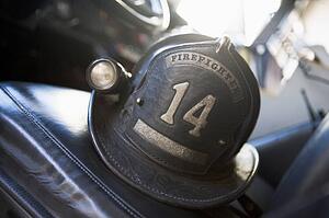 Firefighting helmet in fire engine on seat (selective focus)