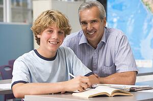 Teacher giving personal instruction to male student