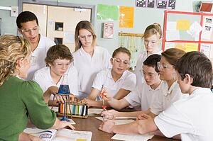 Students receiving chemistry lesson in classroom