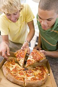 Teenage Boys Eating Pizza 