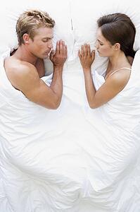 Couple lying in bed sleeping