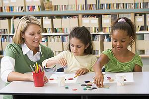 Two students in art class with teacher
