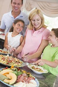 Mother Serving Up Dinner For Family
