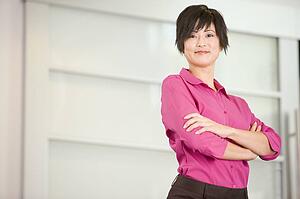 Businesswoman standing indoors smiling
