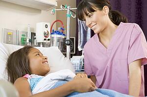 Nurse Talking To Young Patient