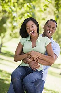 Couple being playful outdoors smiling