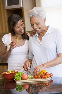 Mother And Daughter Preparing A meal, mealtime Together