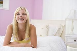 Teenage Girl Lying On Bed