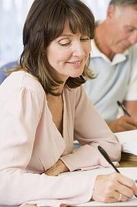 Adult students studying at table (selective focus)