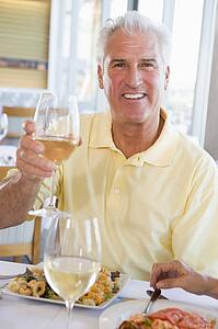Man Enjoying meal, mealtime With A Glass Of Wine 