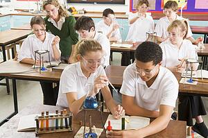 Students performing science experiments in classroom