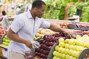 Man shopping for apples at a grocery store