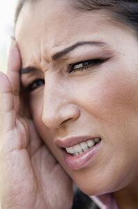 Woman's frustrated face outdoors (selective focus)