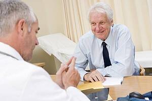Man in doctor's office smiling