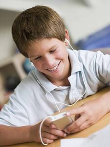 Young Boy Playing With An MP3 Player