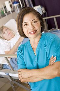 Doctor Standing With Arms Crossed In Her Patients Room 