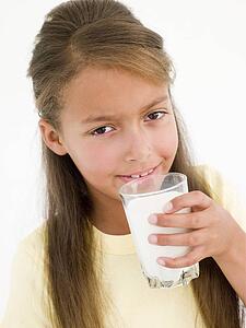 Young girl drinking glass of milk
