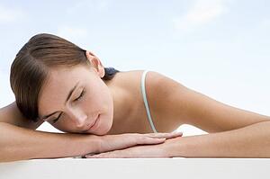 Woman posing outdoors with eyes closed