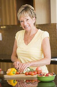 Woman Cutting Up Vegetables