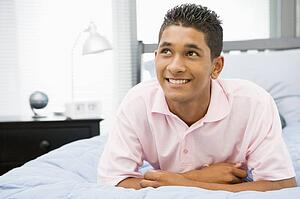Teenage Boy Lying On Bed