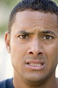 Head shot of man scowling