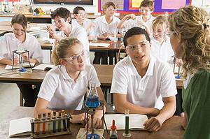 Students performing science experiments in classroom