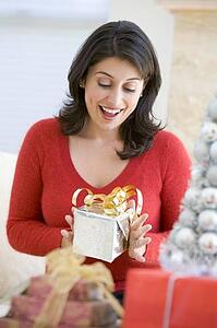 Woman Excited To Open Christmas Present