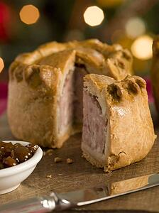 Pork Pie cut on a Board with Chutney