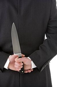 Businessman Holding Knife Behind His Back