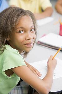 Student in class writing (selective focus)