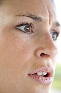 Head shot of woman scowling