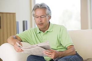Man relaxing with a newspaper