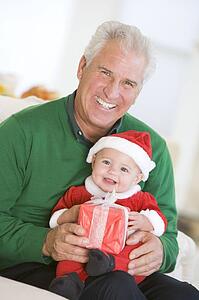 Grandfather With Baby In Santa Outfit
