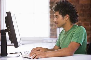 Businessman in office typing on computer