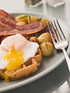 Waffles with Bacon Fried Potatoes and a Broken fried Egg