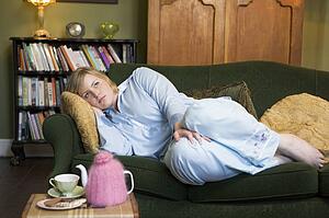 Young woman lying on sofa at home