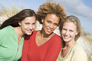 Three women posing outdoors
