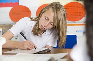 Student in class taking notes