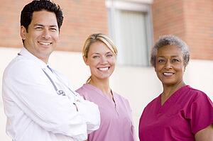 Doctor And Nurses Standing Outside A Hospital