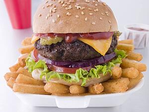 Cheese Burger In A Sesame Seed Bun With Fries