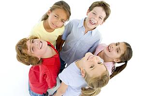 Circle of five young friends smiling