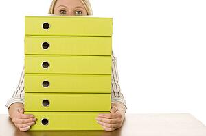 Businesswoman With Stack Of Folders